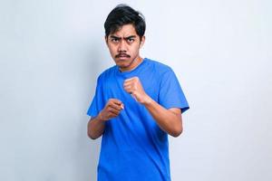 Man punching fist to fight, aggressive and angry attack, threat and violence photo