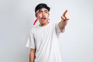 Asian young man pointing forwardmake choosing you gesture photo