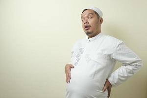 Asian Muslim men feel very full after eating photo