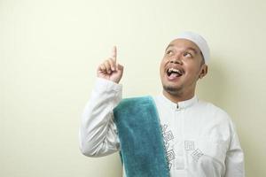 Portrait of young Asian muslim man having good idea photo
