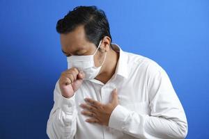 Fat Asian guy wearing a mask is coughing photo