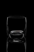 silhouette of an empty glass on a black background photo