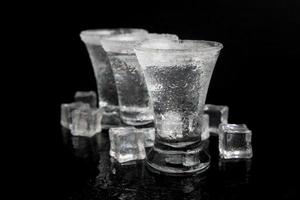 shot of tequila with salt on a black table photo