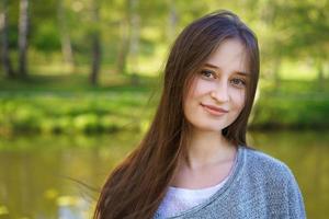 Portrait of a girl on a lake background photo