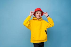 Funny hipster young guy teenager in fashion red panama hat and in yellow photo