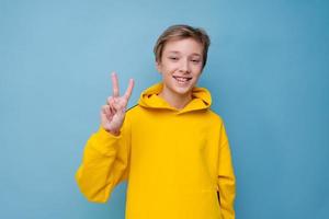 Portrait of attractive young guy showing different hand gestures on blank photo