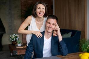 Laughing excited married couple rejoice in their happiness by winning prize photo