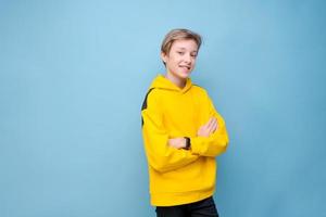 Handsome smiling young european guy teenager speechlessly looking at camera photo