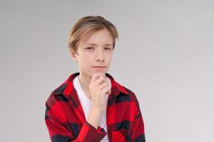 Close-up headshot of confident serious concentrated young man looking at camera photo