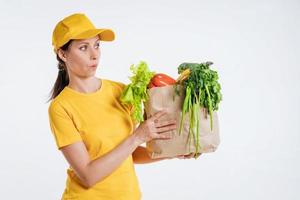 Female food delivery worker with food package photo