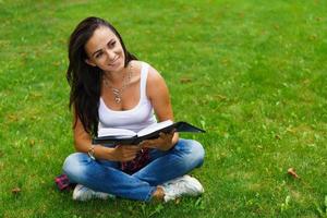 Caucasian woman thinks and writes notes in a notebook, attractive photo
