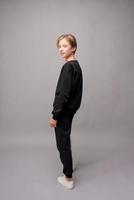 Portrait of a young handsome guy with a stylish haircut in a black sweatshirt photo