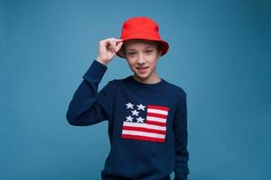 Waist shot happy and contented handsome young man wearing red panama hat photo