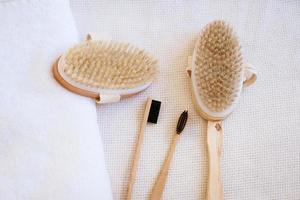 natural wooden massage brushes and dental brushes on the background photo