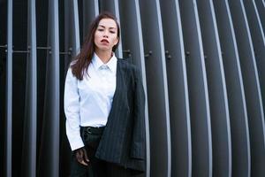 Beautiful business woman in a suit is posing photo