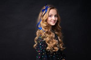 Smiling pretty little caucasian girl 12-10 posing on black background photo