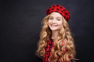 Following her personal style. Little girl in a french style hat. Happy girl photo