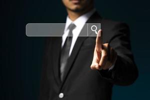 Fingers touching search button with magnifying glass, searching engine icon. photo