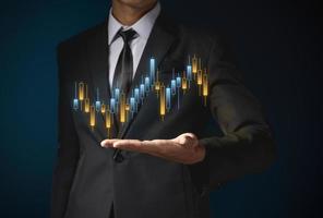 trader is showing a growing virtual hologram stock, invest in trading. photo