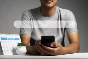 Man using phone searching browsing internet data Information with search bar icon. Networking concept photo
