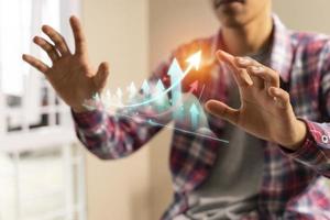 Man enjoyed stock trading at home with virtual holographic graphs and stock market statistics photo