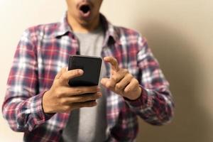 Hipster shocks using a touch screen smart phone. hands close up photo