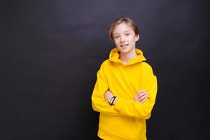 Handsome smiling young european guy teenager speechlessly looking at camera photo