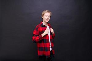 Smiling toothy funny young caucasian teenage guy in simple casual t-shirt photo