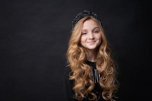 Little funny cute birthday girl, princess 10 years old, wears dark clothes photo