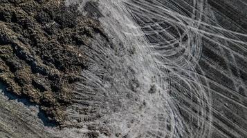 Manure pile on the field. Spring field work. Aerial survey photo