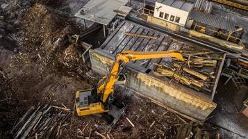 machine is lifting lumber on a wood factory photo