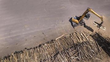 the loader loads the wooden beams in the truck photo