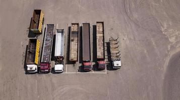 trucks stand in a row Parking lot - top view from the drone photo