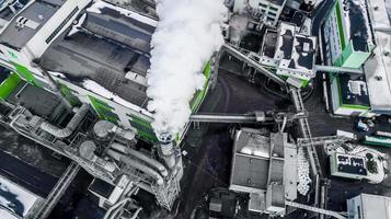 pipes of woodworking enterprise plant sawmill in the morning dawn. Air pollution concept. Industrial landscape environmental pollution waste of thermal power plant photo