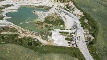 Sand pit with blue water view from drone photo