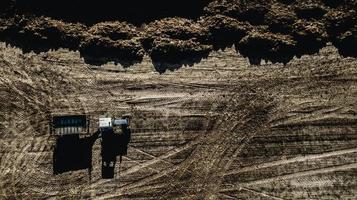 Tractor in the field. Aerial survey. Fertilization photo