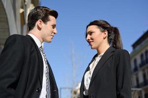 Business people talking outside of company building. Couple working photo