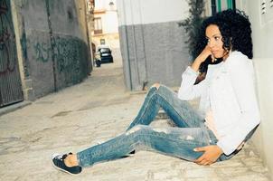 Young black woman, model of fashion in urban background photo