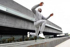 Attractive black man running in urban background photo