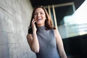 Businesswoman talking with a smartphone in an office building photo