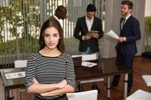 Businesswoman leader with arms crossed in working environment photo