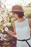 Portrait of young woman in the flowered garden in the spring time photo