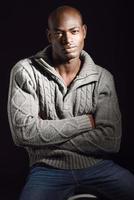 Black man wearing casual clothes in black background photo