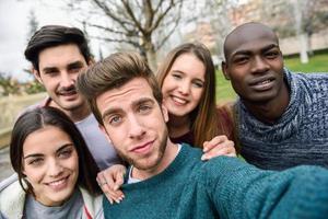 Multiracial group of friends taking selfie photo