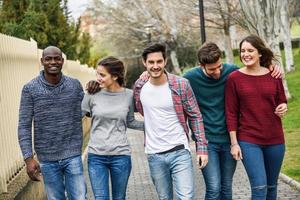 Group of friends having fun together outdoors photo