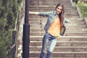 Woman with nice hair wearing casual clothes in urban background. photo