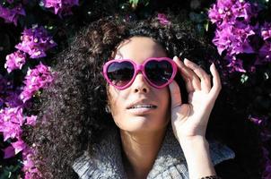 Funny black girl with purple heart glasses photo