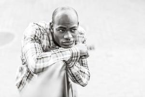 Black man wearing casual clothes in urban background photo