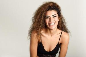 Young happy woman with curly hairstyle smiling photo