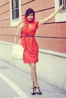 Beautiful woman in urban background. Vintage style photo